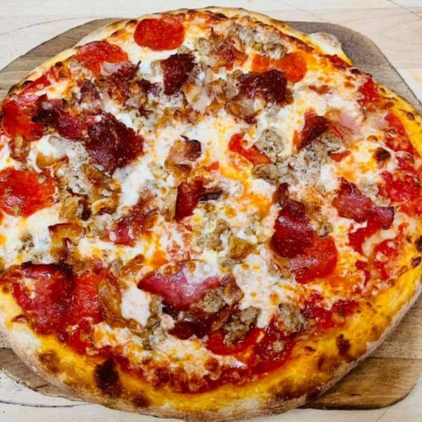 Genaros Restaurant & Pizza's meat lover's pizza, topped with pepperoni, sausage, and bacon.